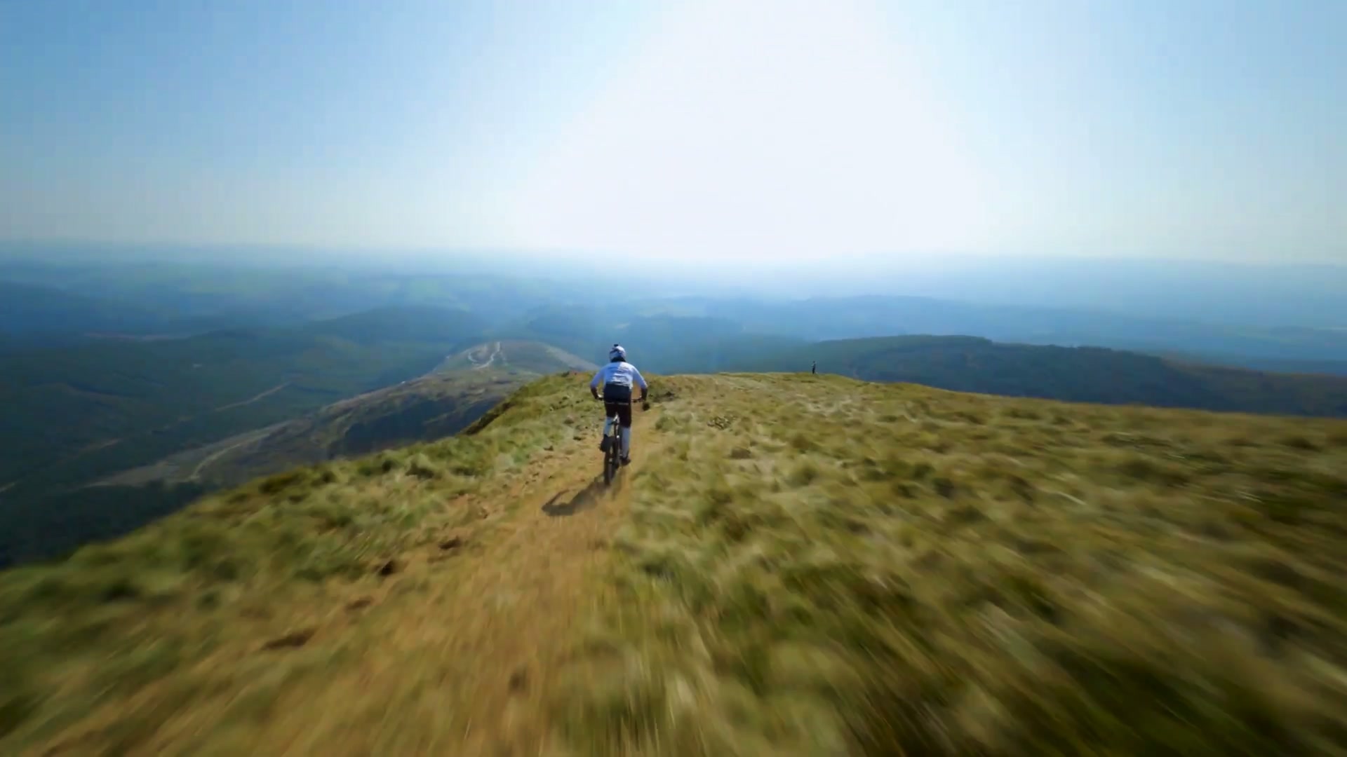 A cyclist on an open mountain ridge